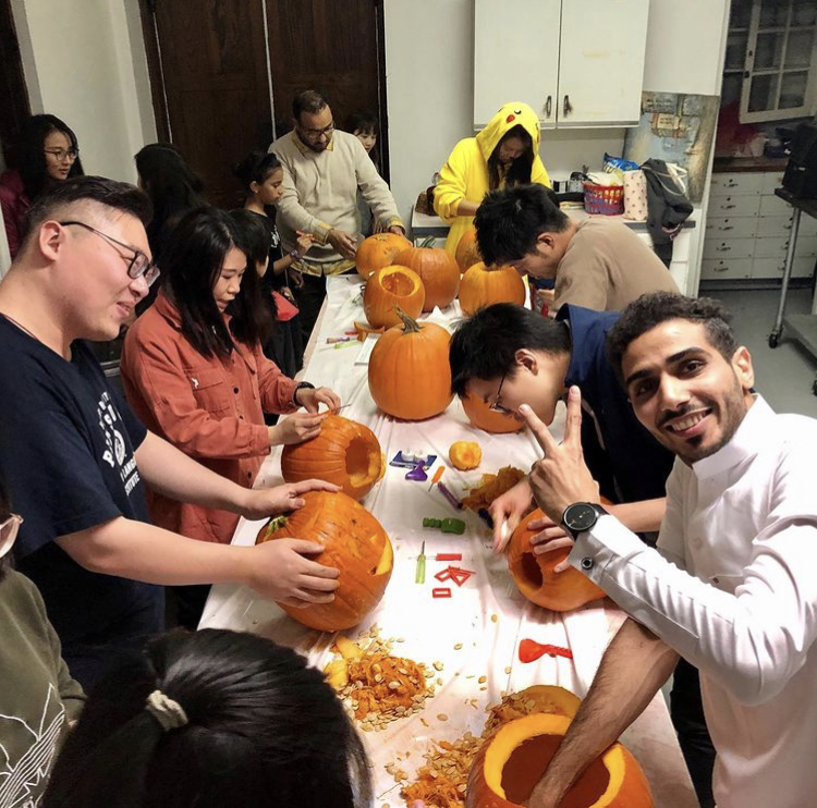ELI Students in the process of carving pumpkins. 