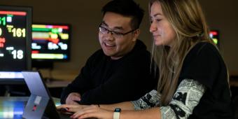 Pitt students looking at a tablet